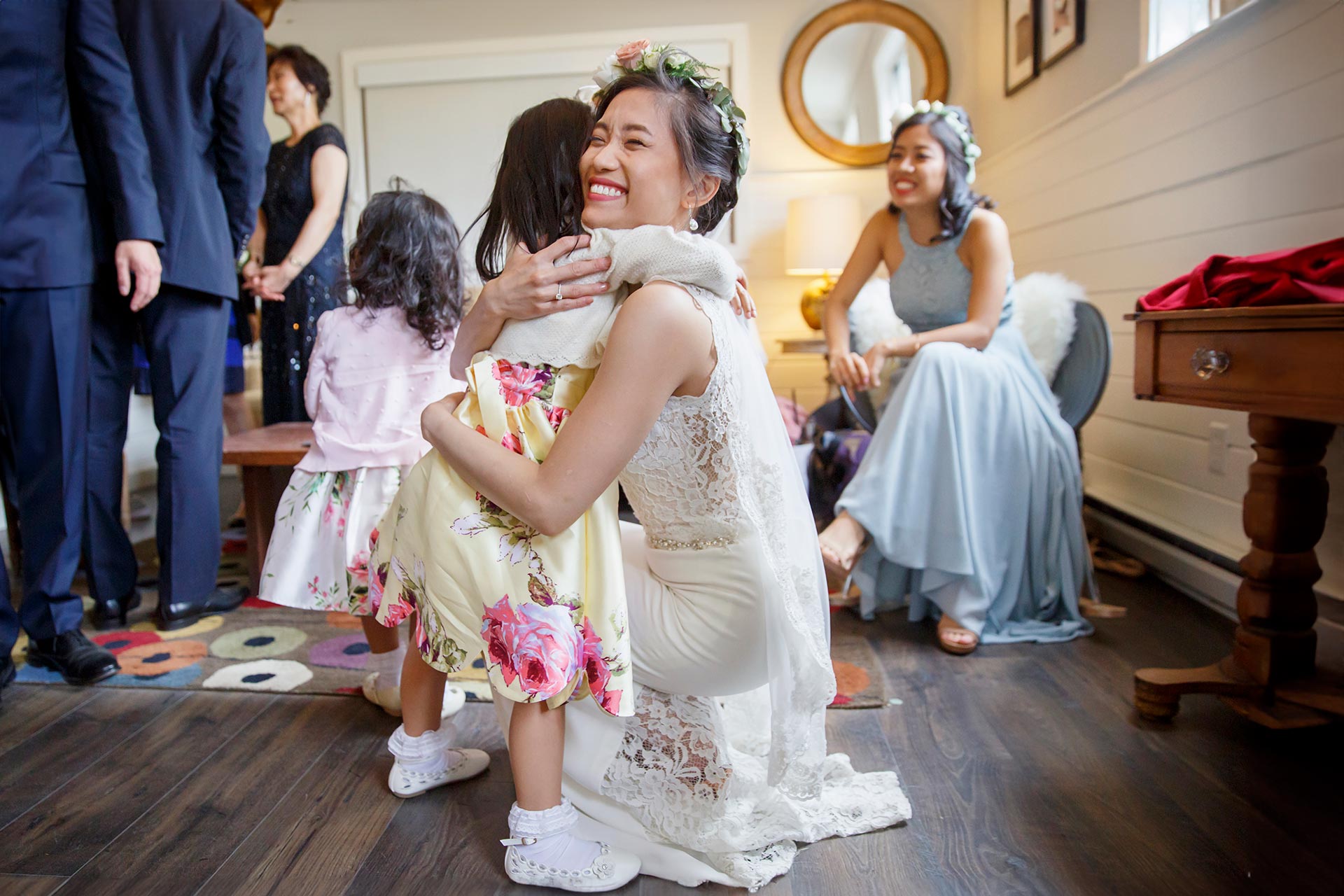 A bride hugs her flower girl before the wedding ceremony.